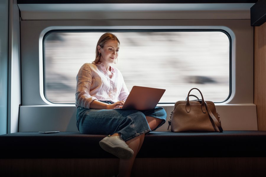 Woman with laptop on train